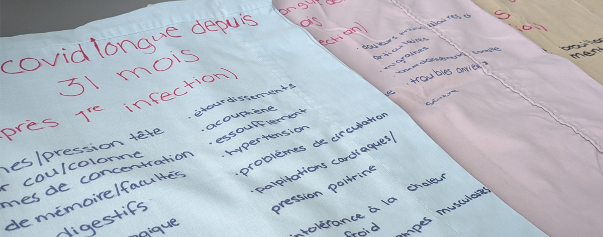 pillowcases-fr A photo of pillowcases. The pillowcases have writing on them that conveys stories of people's struggles with long Covid.